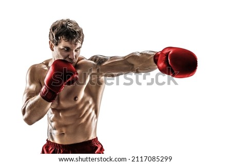 Studio shot of athlete boxer training and practicing jab. Isolated on white studio background. Concept of sport, healthy lifestyle. Red sportswear.  Royalty-Free Stock Photo #2117085299