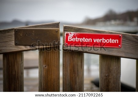 on a red sign at a gate is written in german: Betreten verboten