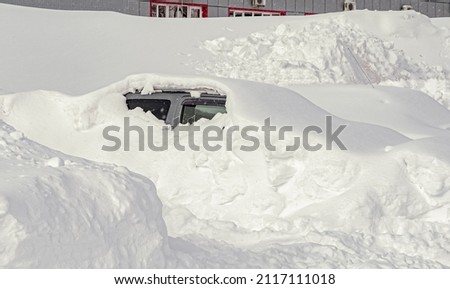 Vehicles covered with snow during a winter blizzard on the road.The roads are snow-blocked. Royalty-Free Stock Photo #2117111018