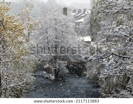 falling snow over the river in the west yorkshire town of hebden bridge Royalty-Free Stock Photo #2117113883