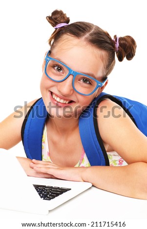 A picture of a schoolgirl learning with computer over white background