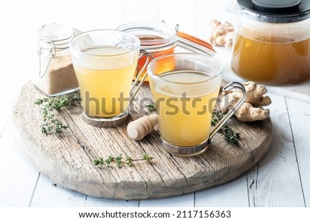 Elixir tea made with thyme, ginger and honey, ready for serving. Royalty-Free Stock Photo #2117156363