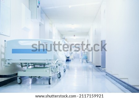 Where healing happens. Shot of a hospital bed in an empty corridor of a modern hospital. Royalty-Free Stock Photo #2117159921
