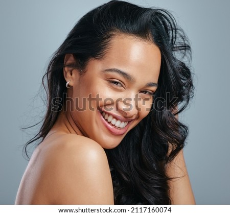 Nourished hair feels so amazing. Studio portrait of an attractive young woman posing against a grey background. Royalty-Free Stock Photo #2117160074
