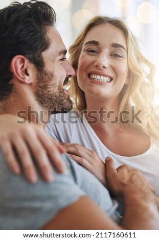 My hubby makes me so happy. Shot of a young couple relaxing at home. Royalty-Free Stock Photo #2117160611