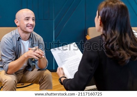 Human resource manager is interviewing new applicant while looking at the resume for the work experience profile Royalty-Free Stock Photo #2117160725