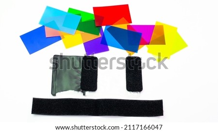 Overhead multi-colored photo filters for photo flash, on a white background. Creative photography color filters and lighting equipment.