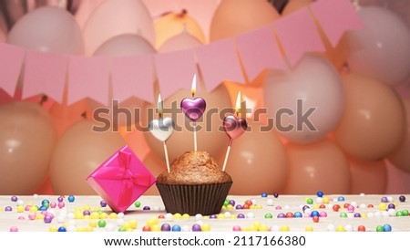 A congratulation for any holiday for a muffin girl with hearts and a gift box, light candles. Copy space, congratulations, decorations balloons with burning candles. Birthday card with cupcake