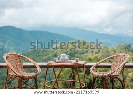 teapot set on table in the morning with mountain view at countryside home or homestay. Vacation, travel and trip concept Royalty-Free Stock Photo #2117169599