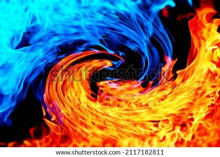 Background image of blue and red flames facing each other Royalty-Free Stock Photo #2117182811