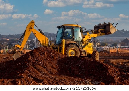 African driver working on an earthmoving machine in South Africa Royalty-Free Stock Photo #2117251856