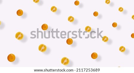 Colorful fruit pattern of fresh orange on white background with shadows. Top view. Flat lay. Pop art design