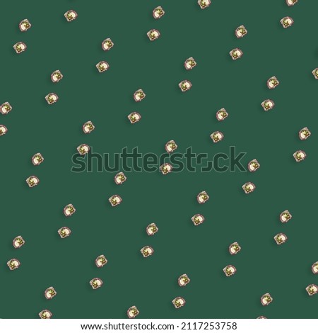 Colorful pattern of japanese sushi rolls on green background. Top view. Flat lay. Pop art design