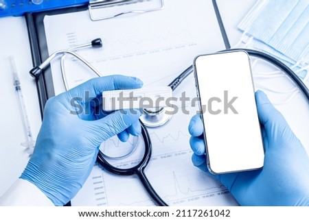 Cellphone mockup. Syringe with needle, hospital healthcare charts, doctor stethoscope and black smartphone with blank screen for medical equipment background with clipping path, copy space