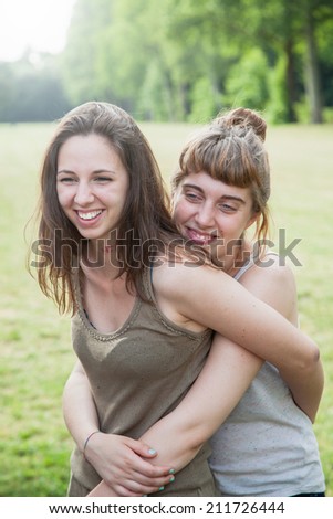 Young couple of girls at the park on a summer day
