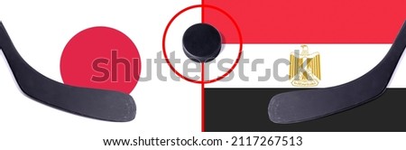Top view hockey puck with Japan vs. Egypt command with the sticks on the flag. Concept hockey competitions