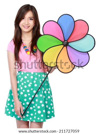 attractive young asian woman with colorful windmill isolated over white background