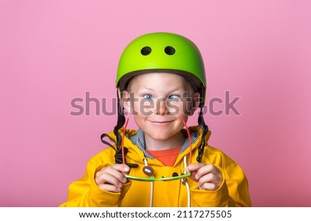 Comic little kid boy make grimace with eyes strabismus. Child with crosses-eyes with glasses in hands. Happy child with squint eyes. Royalty-Free Stock Photo #2117275505
