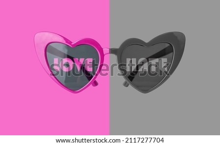 Love hate concept. Heart glasses on pink and grey background. High quality photo