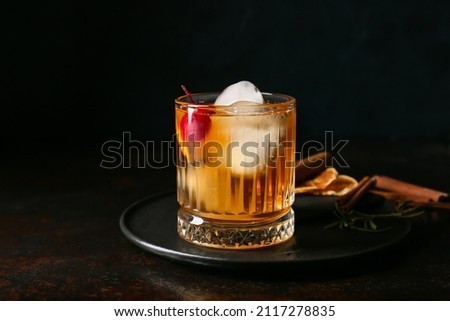 Glass of delicious Old Fashioned Cocktail on black background Royalty-Free Stock Photo #2117278835