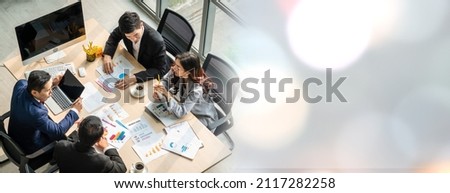Business people group meeting shot from top widen view in office . Profession businesswomen, businessmen and office workers working in team conference with project planning document on meeting table . Royalty-Free Stock Photo #2117282258