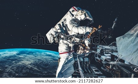 Astronaut spaceman do spacewalk while working for spaceflight mission at space station . Astronaut wear full spacesuit for operation . Elements of this image furnished by NASA space astronaut photos . Royalty-Free Stock Photo #2117282627
