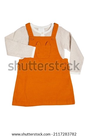 Summer dress isolated. Closeup of a beautiful orange baby girl dress and a beige shirt with isolated on a white background. Clipping path. Children spring fashion.