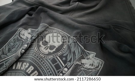 a picture of a skull in a black jacket