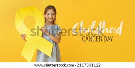Awareness banner for International Childhood Cancer Day with little girl holding golden ribbon Royalty-Free Stock Photo #2117301122