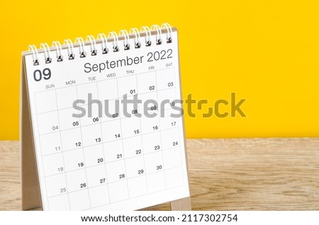 The September 2022 desk calendar on wooden table with yellow background. Royalty-Free Stock Photo #2117302754