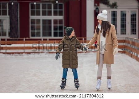 Happy caucasian family, enjoying their time skating together.