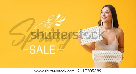Beautiful woman with gifts on yellow background. Spring sale