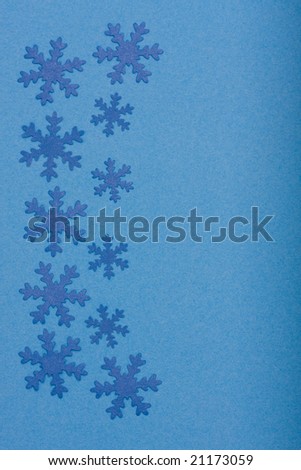 winter background - composition of snowfaleks on blue