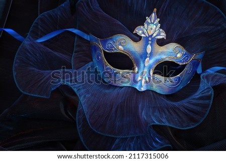 Photo of elegant and delicate Venetian mask over blue dark background Royalty-Free Stock Photo #2117315006