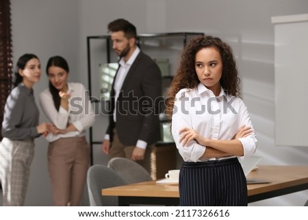 African American woman suffering from racial discrimination at work Royalty-Free Stock Photo #2117326616