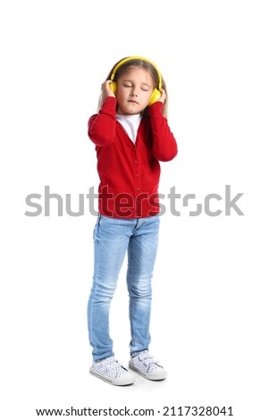 Funny little girl listening to music on white background