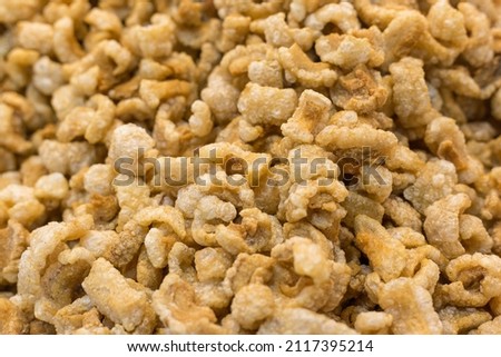 Pork crackling (pork snack, pork scratching) is fried pork skin as snack and we can eat it with noodles in Thai food style. Royalty-Free Stock Photo #2117395214