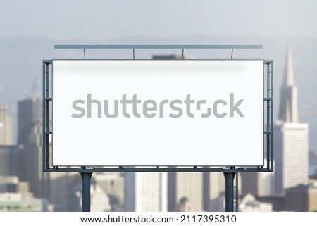 Blank white horizontal billboard on city buildings background at daytime, front view. Mockup, advertising concept