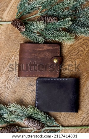 brown genuine leather wallets on a wooden table