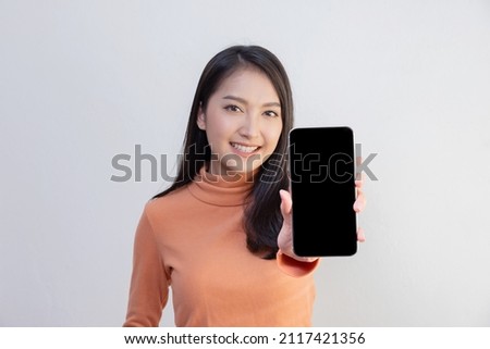 Asian Woman Show Mobile Phone Screen with Blank Copy Space Royalty-Free Stock Photo #2117421356