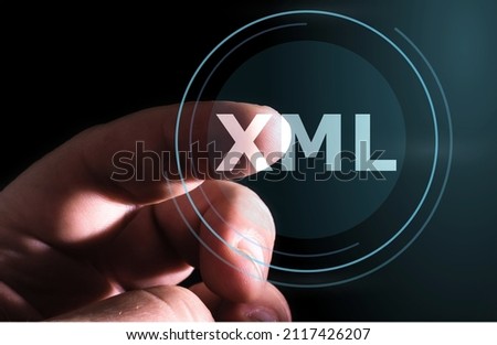 Hand pressing XML button on virtual screens. Extensible Markup Language 