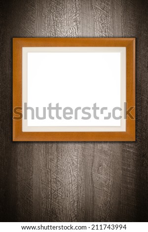 Old picture frame on vintage wood wall.