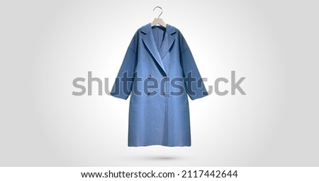 Fashionable women Faux shearling coat on a hanger isolated on green background.  Composition of clothes. Flat lay, top view, copy space. Winter clothes pattern. Ladies' Trench Coat. Pattern