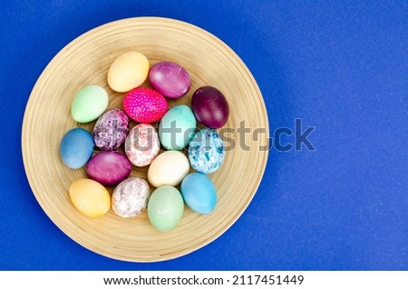 Decorated handmade Easter eggs for the holiday season on blue background. Creative minimal abstract  concept. Photo