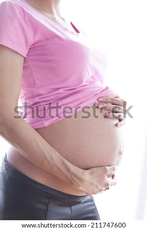 Photo of an attractive  woman who is 32 weeks pregnant,silhouette