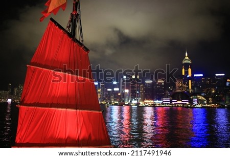 Chinese red junk with the victoria harbor night view background in hong kong