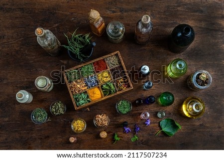 Top view of dried herbs, essential oils, salts, in vitage containers