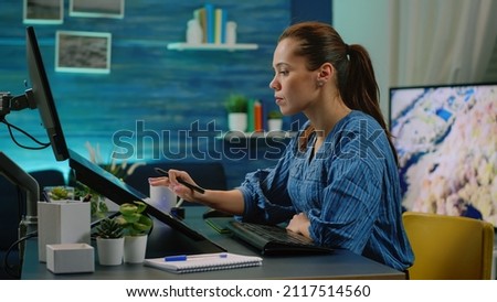 Woman photographer holding stylus and editing pictures using touch screen monitor at photography studio. Media editor retouching photos on computer app for image production. Photo retoucher