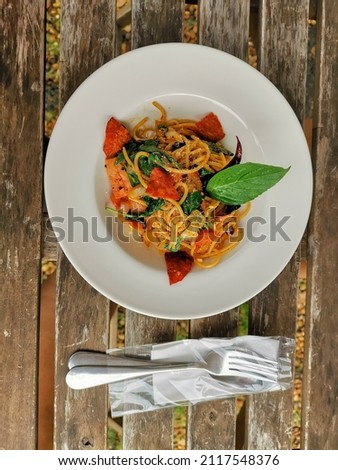 Spaghetti with Dried Chili  Spaghetti on a white plate on a distinctive wooden table.  Just look at the picture and you will feel the deliciousness.