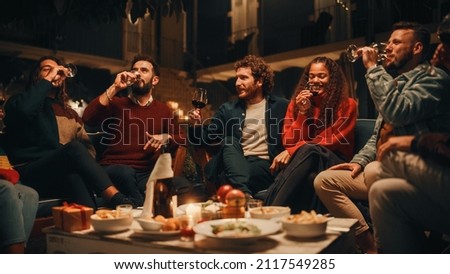 Big Dinner Garden Party Celebration with Friends on a Warm Summer Evening. Beautiful People Enjoy Life on a Terrace, Talk, Relax on Weekend, Have Fun, Drink Wine, Give Toasts and Eat Homemade Food. Royalty-Free Stock Photo #2117549285